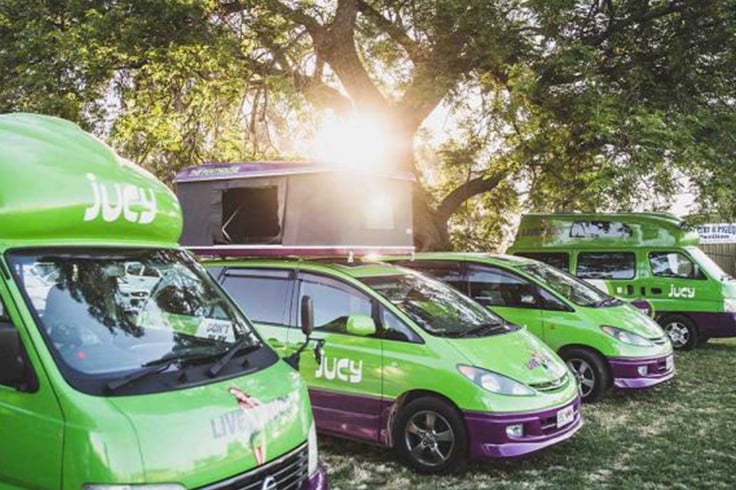 jucy campervans lined up at music festival in australia