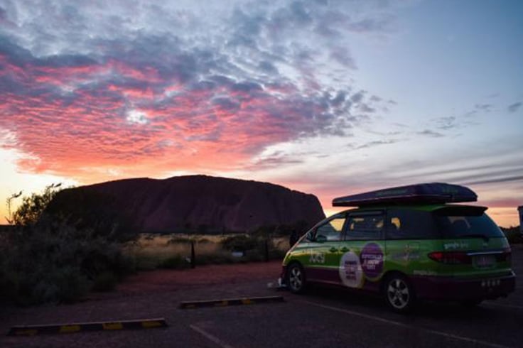 jucy camper parked near uluru national park at sunrise